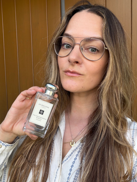 A selfie of Allure content director Sophia Panych holding the Jo Malone London Nectarine Blossom  Honey Cologne